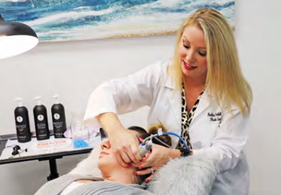 Heather giving a client a hydrafacial